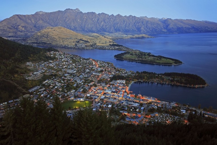 New Zealand, with its 4.4 million residents, welcomes both tourists and new businesses. Here, the lights of Queenstown can be seen from the air.